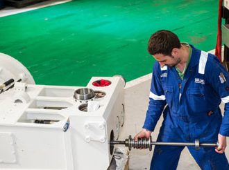 Pump service and support - Removing a plunger from an offshore reciprocating pump.