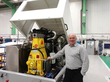 Julian standing next to a high pressure waterjetting pump unit.